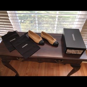 Iconic Chanel cap toe ballerina flats in classic beige and black.